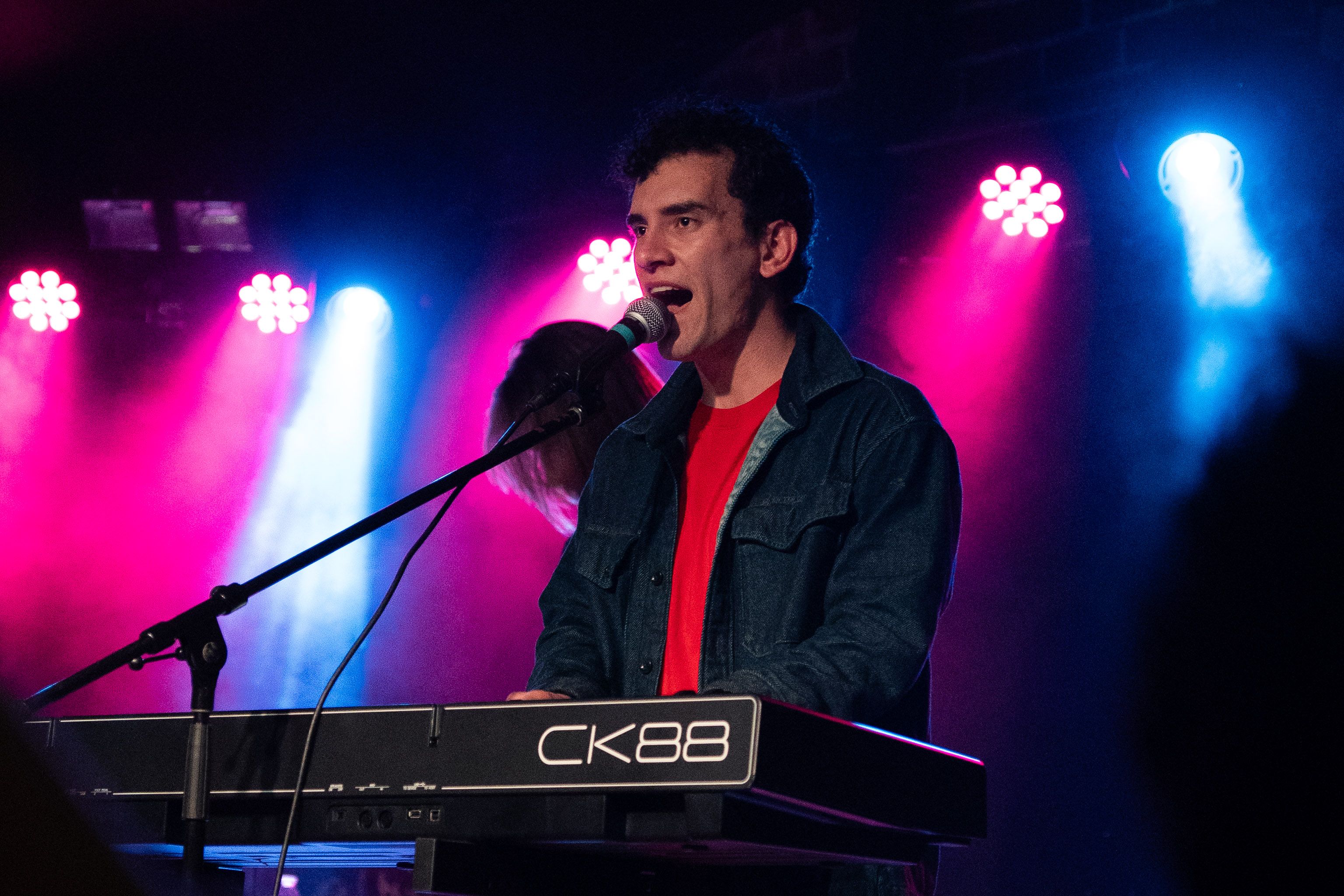 Singer kneeling at the edge of the stage.