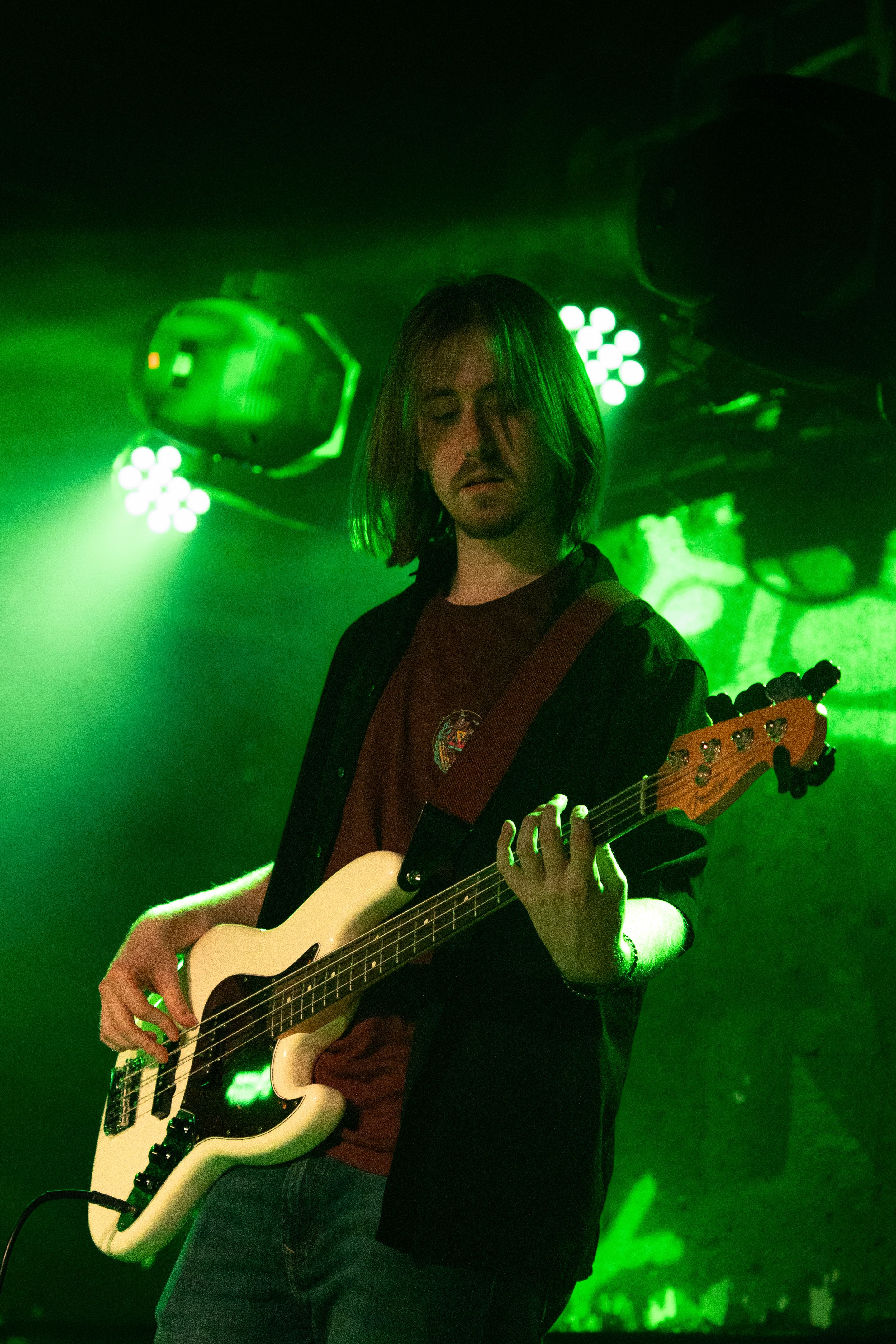 Singer kneeling at the edge of the stage.
