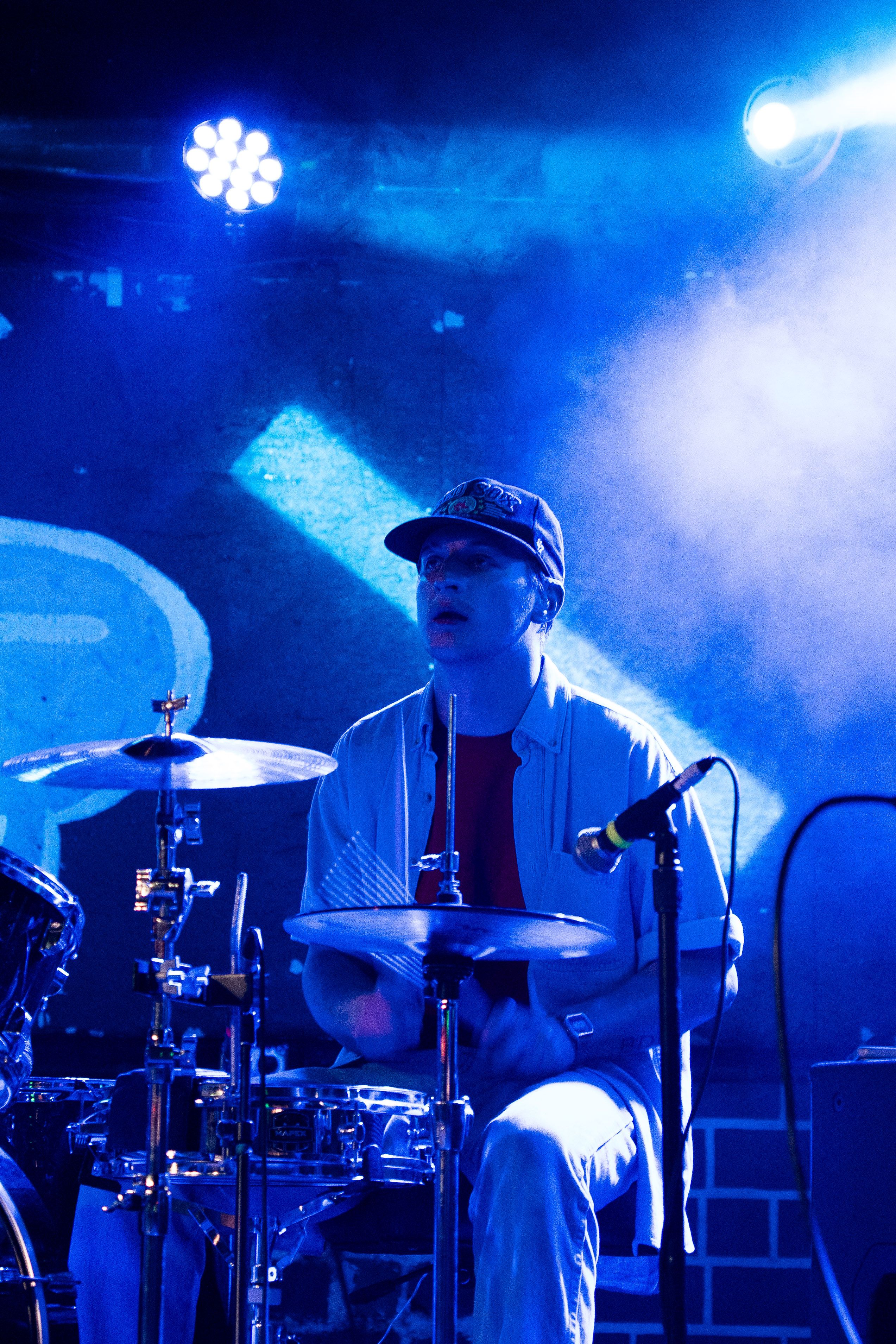 Singer kneeling at the edge of the stage.