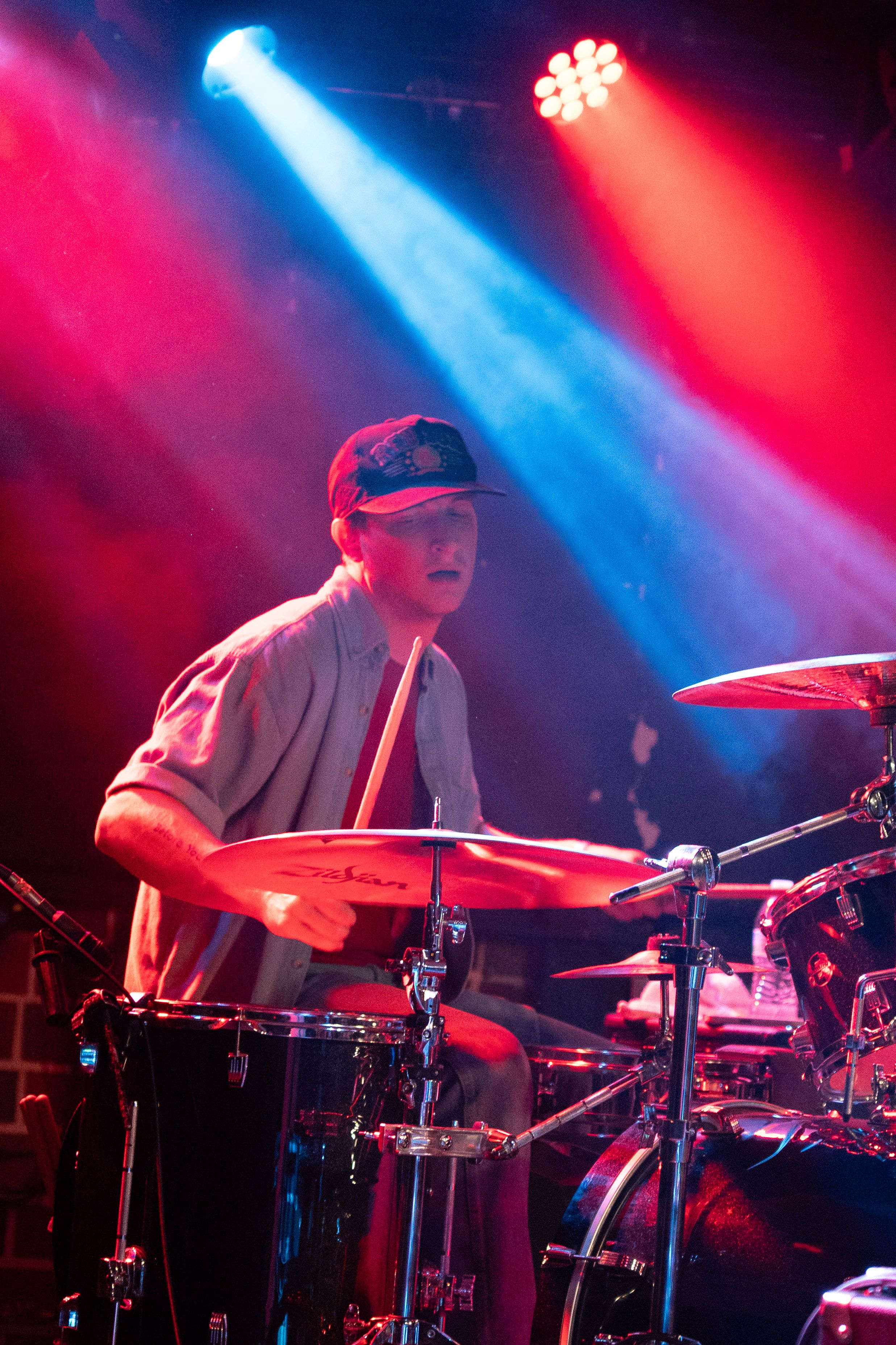 Singer kneeling at the edge of the stage.